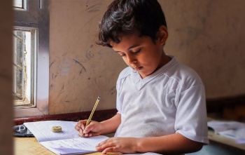 Boy in Yemen learning in class