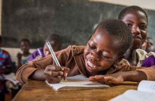 Child in Malawi learning in class