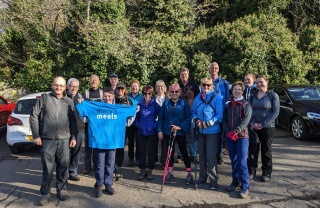 Mary's Meals supporters pose for picture with hiking gear and Mary's Meals t-shirts ahead of challenge