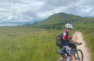 A young boy, Cameron, on his bike on a cycle path on the West Highland Way