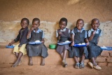 Schoolchildren eating Mary's Meals in Malawi 