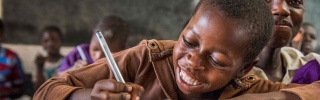 Child in Malawi learning in class