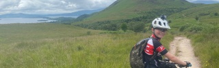 A young boy, Cameron, on his bike on a cycle path on the West Highland Way