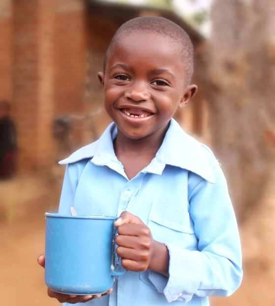 Image of child in Malawi holding their school meal