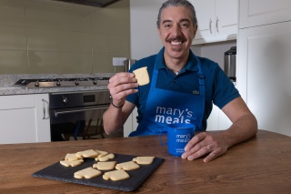 Giuseppe Dell'Anno sits at a table with biscuits