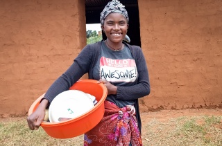 Volunteer cook Eliane stands outside of her school