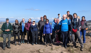 A large group of Mary's Meals supporters at the top of a hill having climbed it