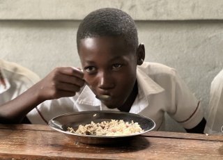 Child eating in Haiti 