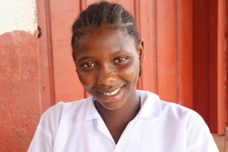 Isatu, a girl from Liberia, standing smiling