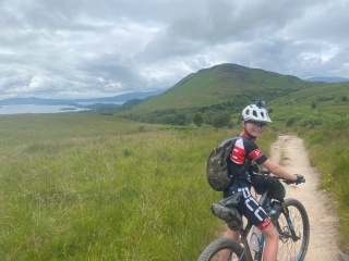 A young boy, Cameron, on his bike on a cycle path on the West Highland Way