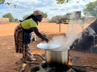 A cook in Mozambique cooking outside