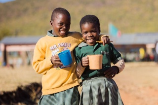 Image of children holding thier Mary's Meals