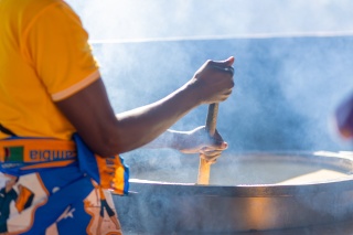 A large pot of porridge being stirred, Zambia