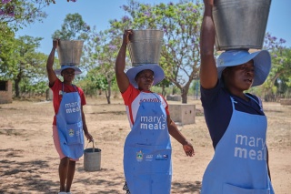 Group of volunteers carrying food and water