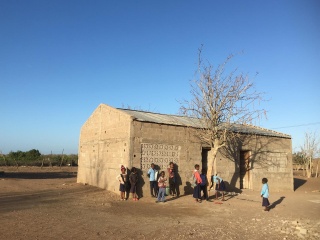 Children in front of a school structure