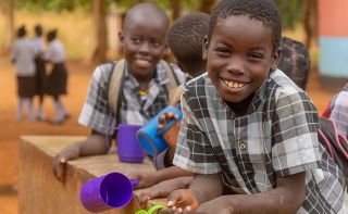 Image of a child holding their mug