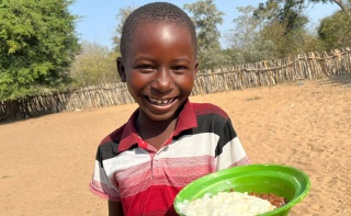 Image of a child holding thier school meal