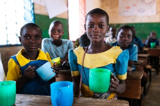 Image of children in Malawi receiving their school meals in class